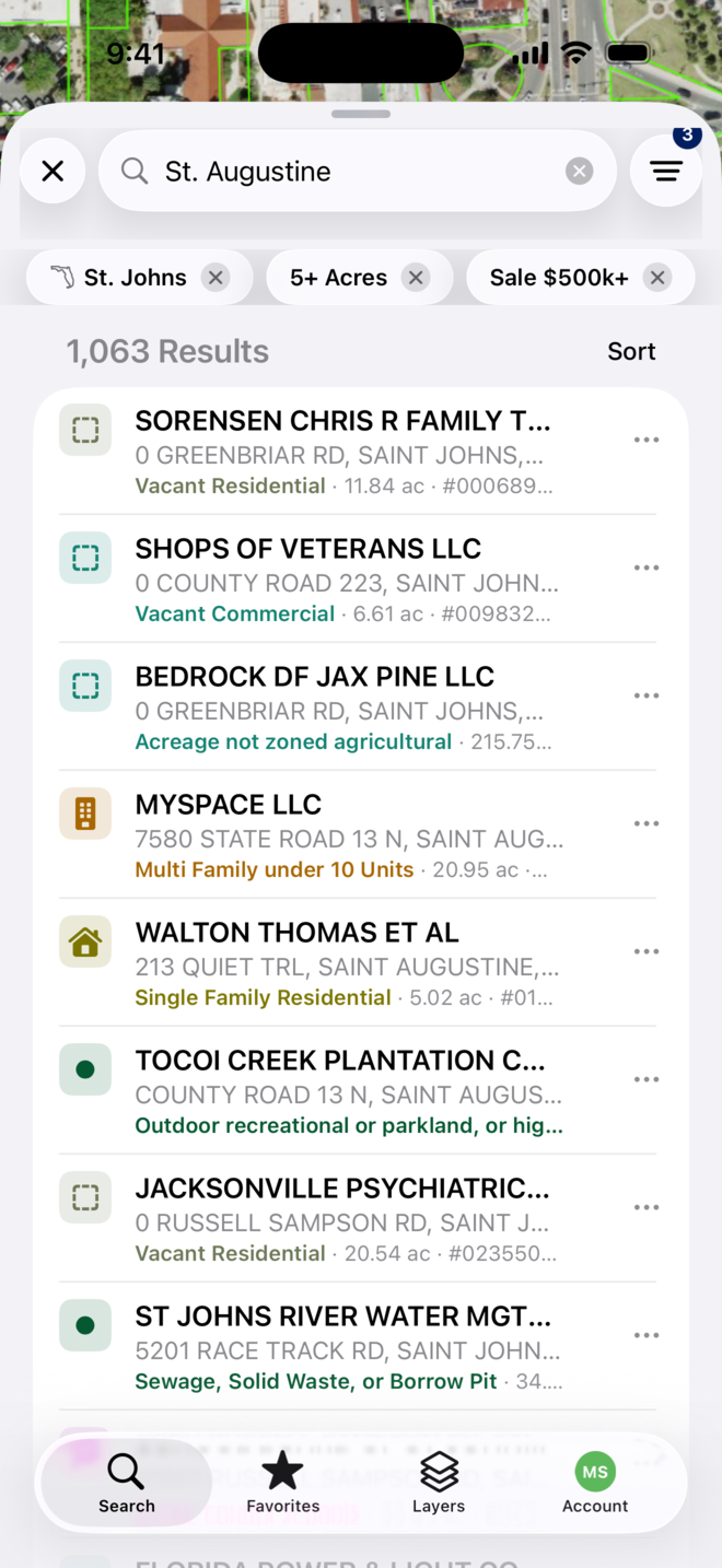 Filtered results in the MapWise app: chips for St. Johns, 5+ Acres and Sale $500k+, 1,063 Results, and rows with owner, address, land use and acreage.